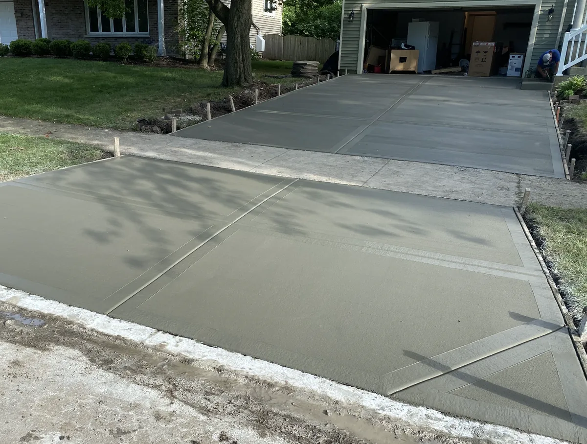 Freshly poured residential concrete driveway with clean control joints