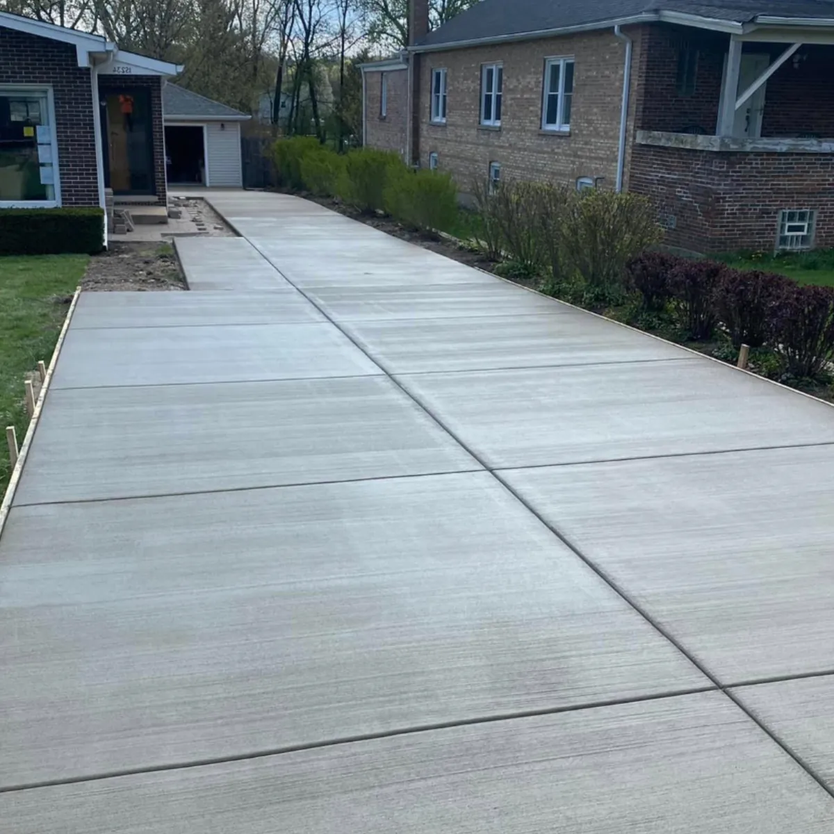 Backyard concrete patio with a broom finish